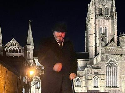 Andrew Ross (Tour guide) standing in front of Durham Cathedral on an evening