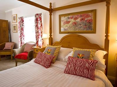 The Penny Red bedroom at The Old Post Office Durham with four poster bed