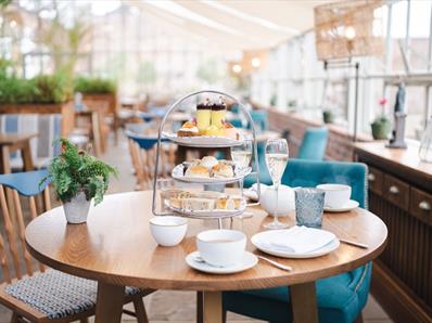 The Glass House restaurant with a table set for afternoon tea.