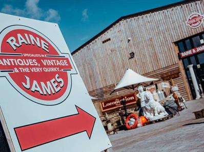 A sign saying Raine James Antiques