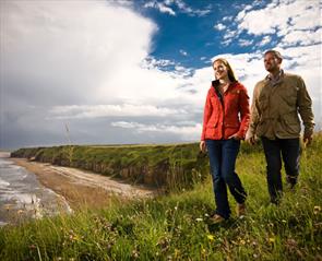 Walking in Durham couple on cliff tops at the coast