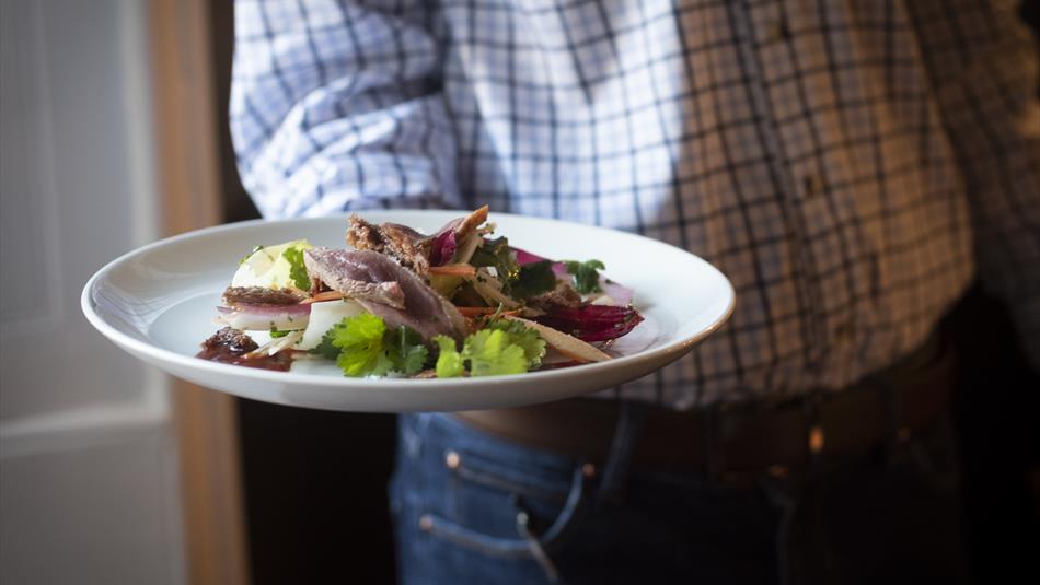 Waiter serving food at Lord Crewe Arms