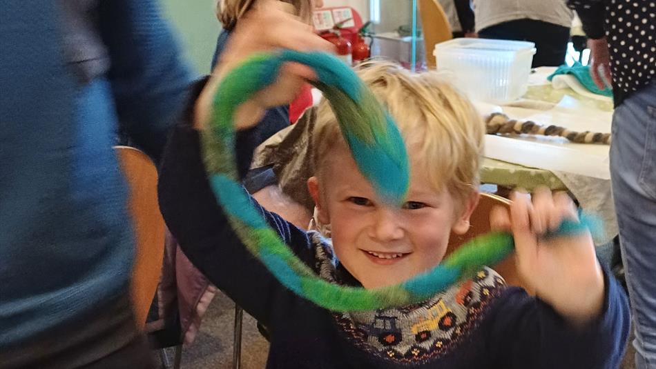 Boy holding felt snake