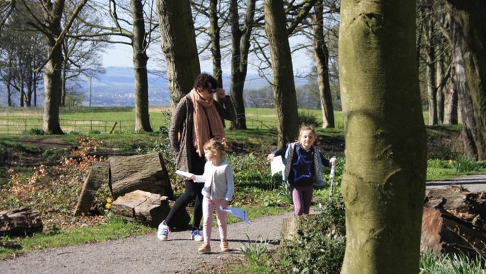 Family walking in the grounds of Ushaw on a sunny day.
