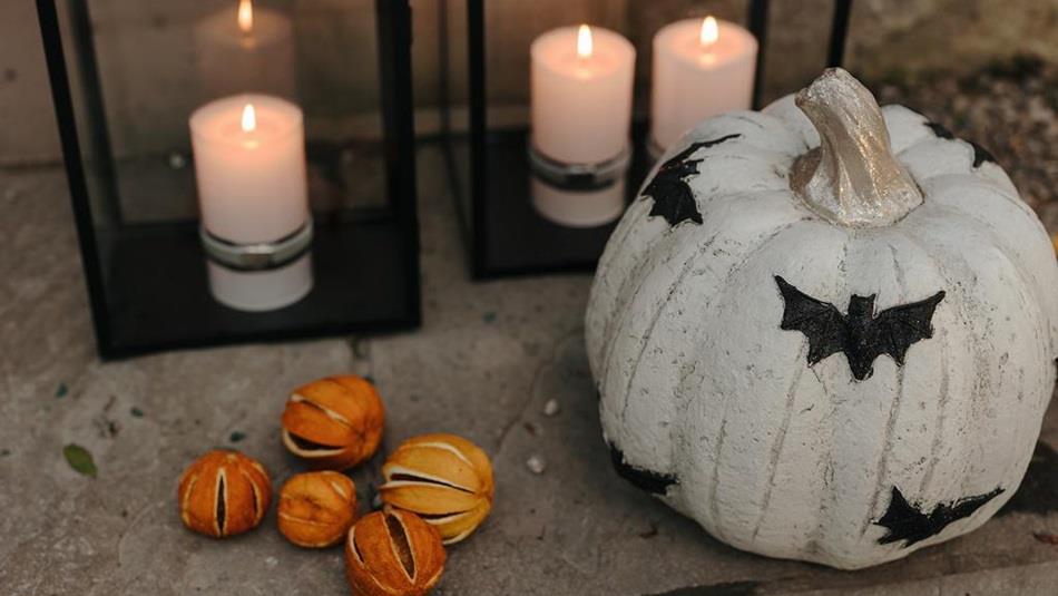A decorated pumpkin and candles