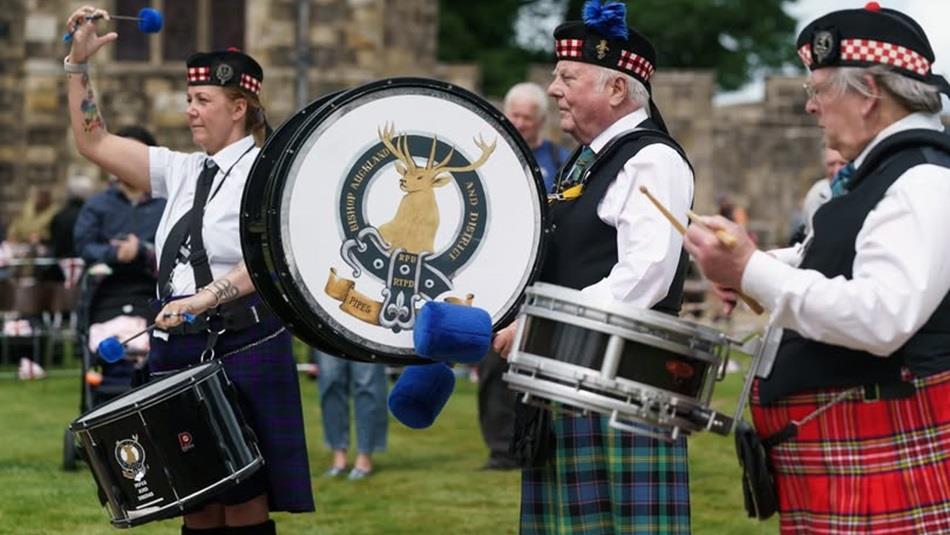 Three drummers performing