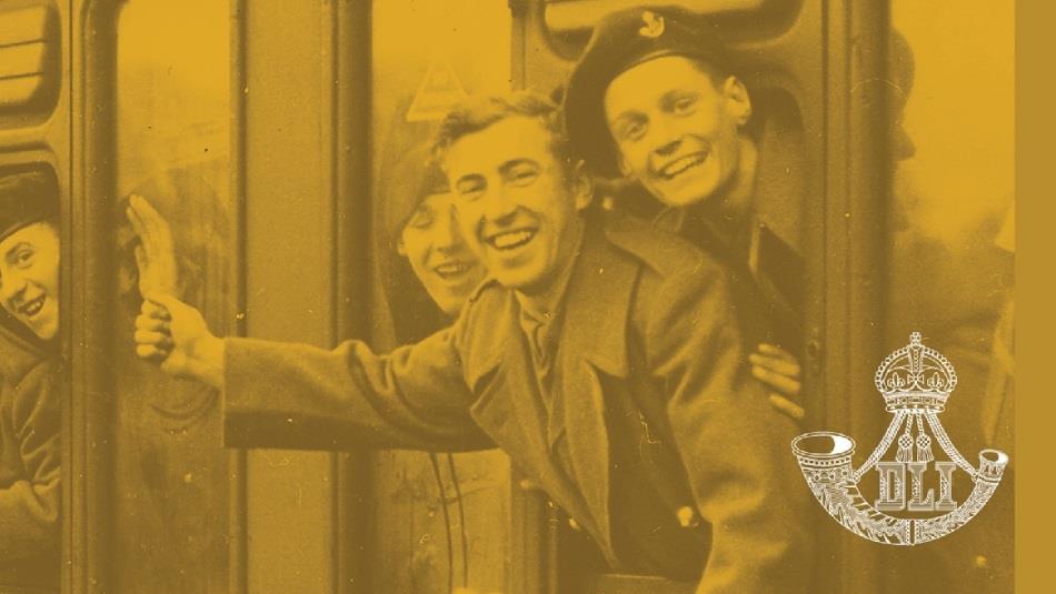 Sepia photograph showing members of The Durham Light Infantry leaning from the windows of a train.