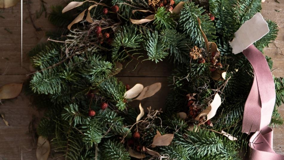 A Christmas Wreath with a pink ribbon
