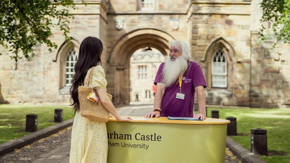 A castle guide and a visitor at Durham Castle