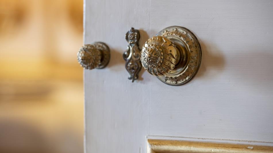 Behind the Scenes Tour of Raby Castle. An open white door, close up view of handle and lock..