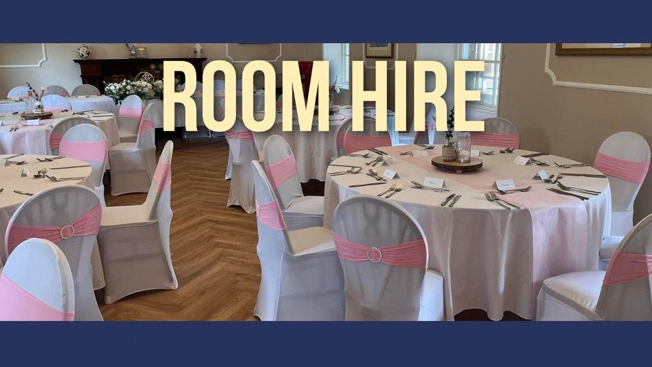 Dining room set up with round tables.  White table and chairs coverings - chairs with a pink sash.