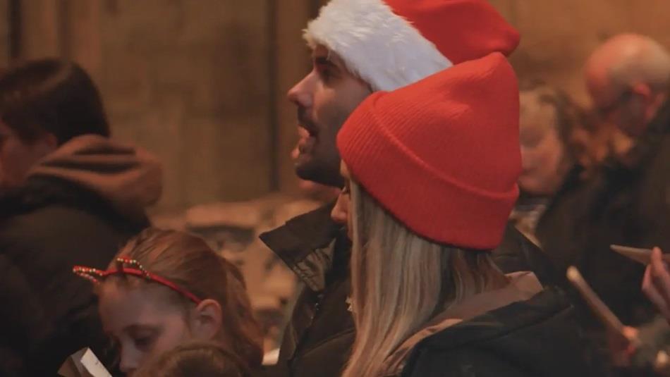 A family attending Carols for All at Durham Cathedral.