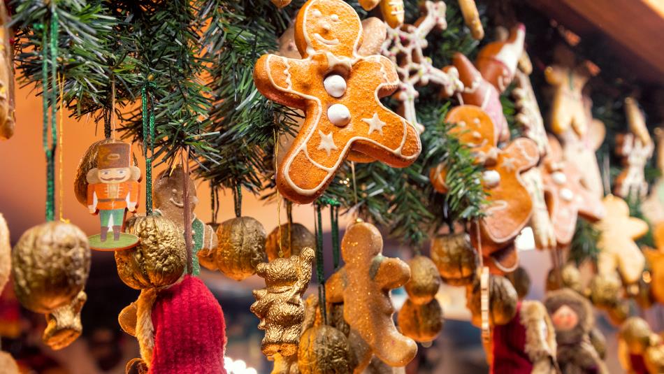 Christmas decorations such as gingerbread hanging from Christmas stall at Christmas Fair.