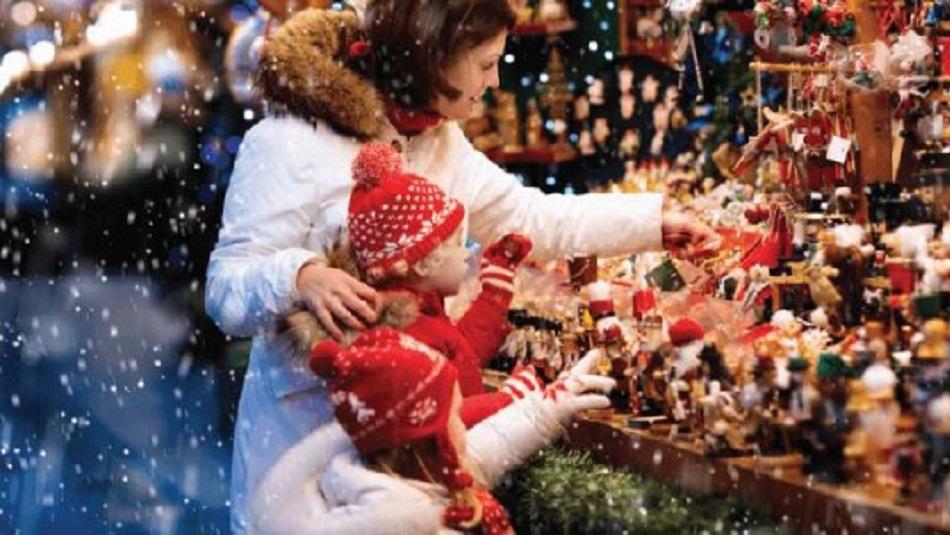 Woman and child looking at a stall display Christmas decorations.