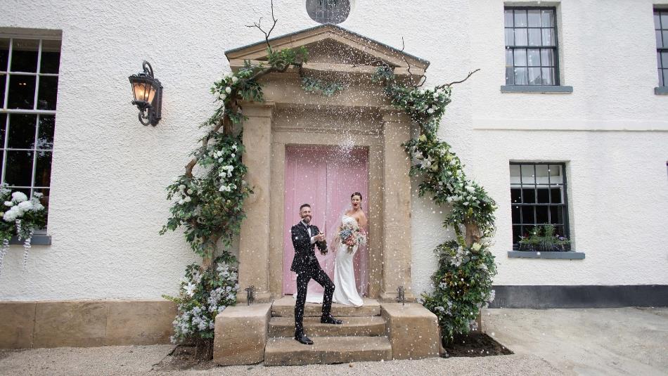 Wedding couple on the doorstep of the hotel