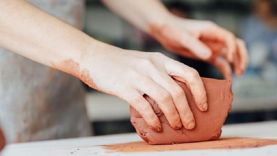 someone working with a block of clay