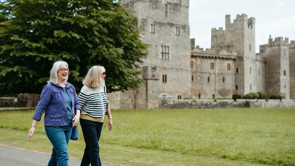 Two women walking in the grounds of Raby Castle