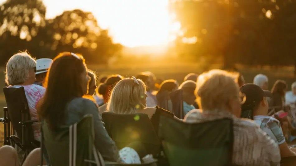 An audience watching outdoor cinema at Raby Castle