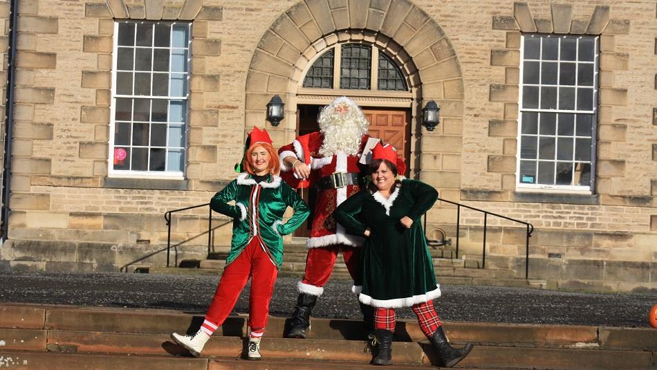 Santa and two elves outside of Ushaw