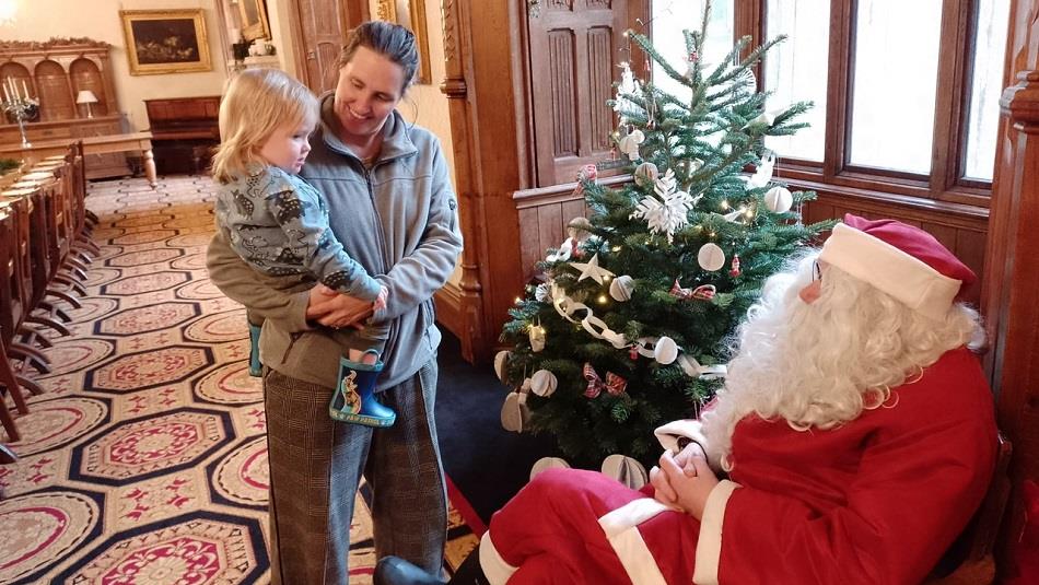 Santa Claus greeting a child at Ushaw