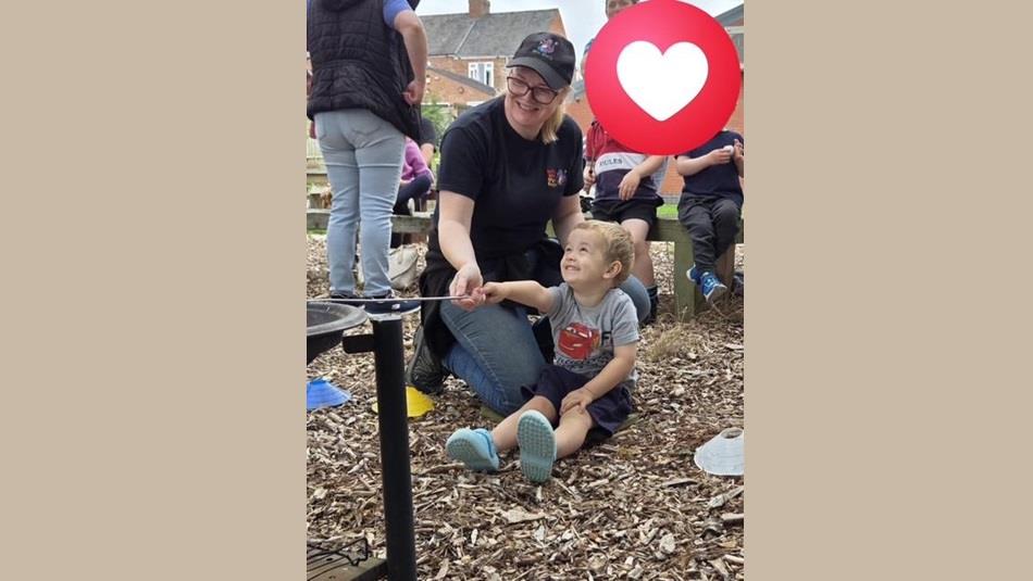Adult and child taking part in the Forest School
