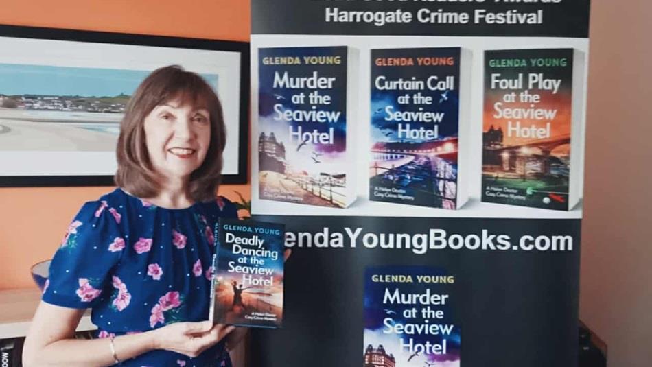 Glenda Young holding her new book Deadly Dancing at the Seaview Hotel.