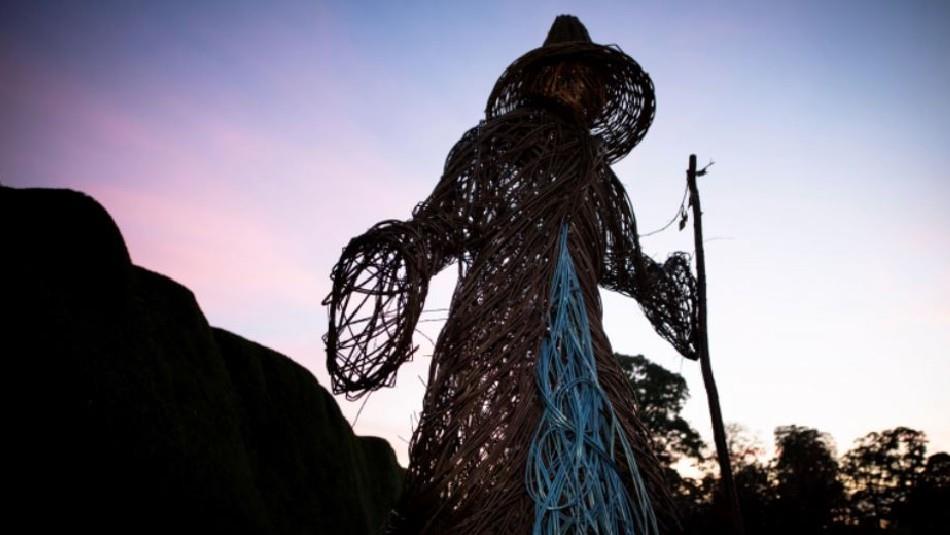 wicker Halloween witch. Trees in background.