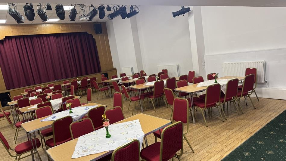 A community hall set out with tables and chairs