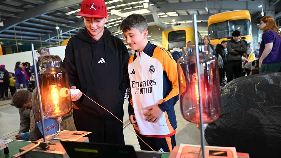 Two children participating in hands-on science experiments at Locomotion.