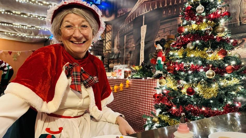 Mrs Claus sitting beside the Christmas Tree at Adventure Valley