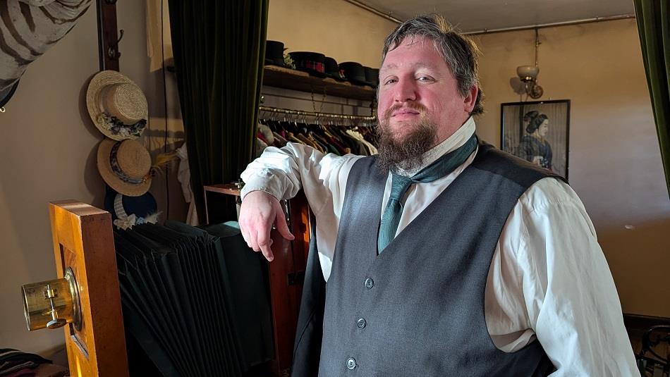 The Beamish Museum photographer standing beside an antique camera