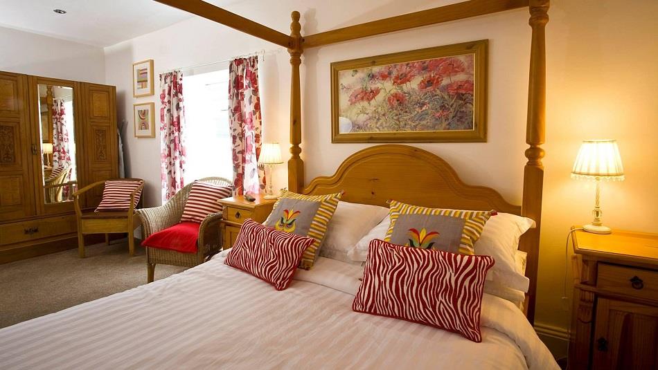 The Penny Red bedroom at The Old Post Office Durham with four poster bed