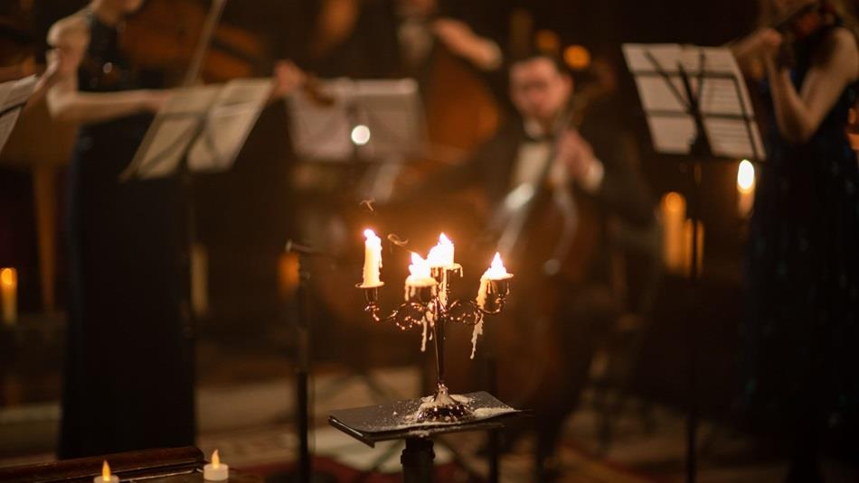 Orchestra playing in candlelight