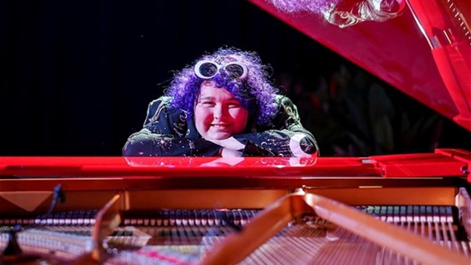 Amity sitting at a piano