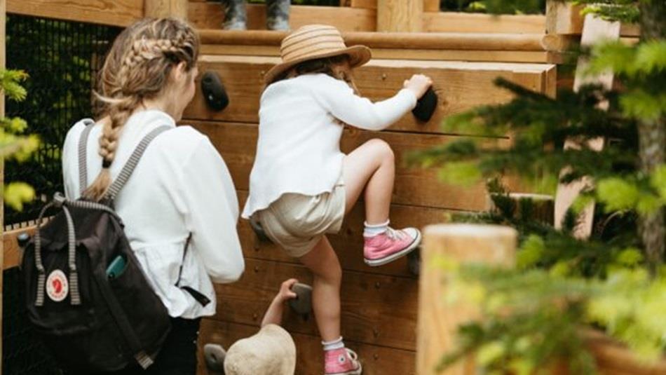 Child playing at the Plotters Forest with an adult at Raby Castle