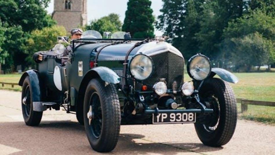 Vintage Sports Car with church in the background