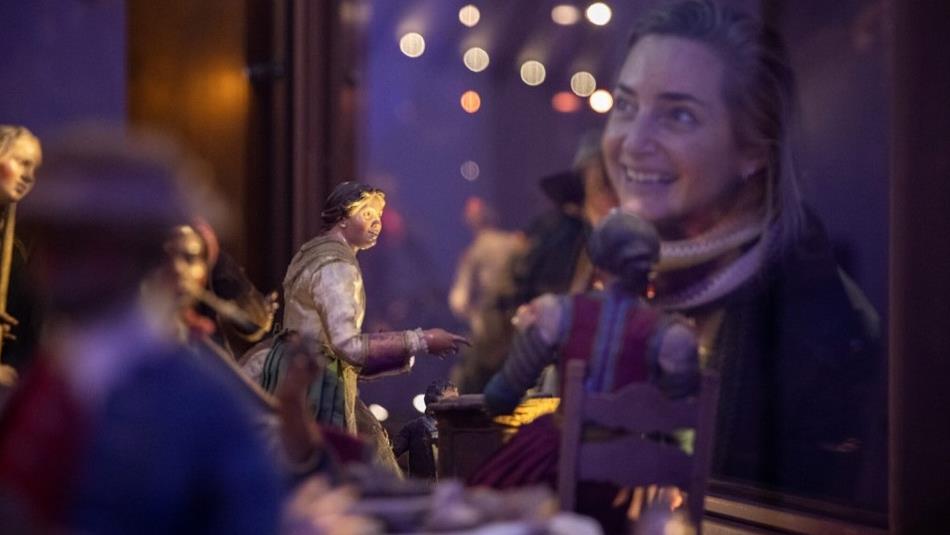 A woman looking at the Neapolitan Nativity scene at The Faith Museum, Auckland Palace