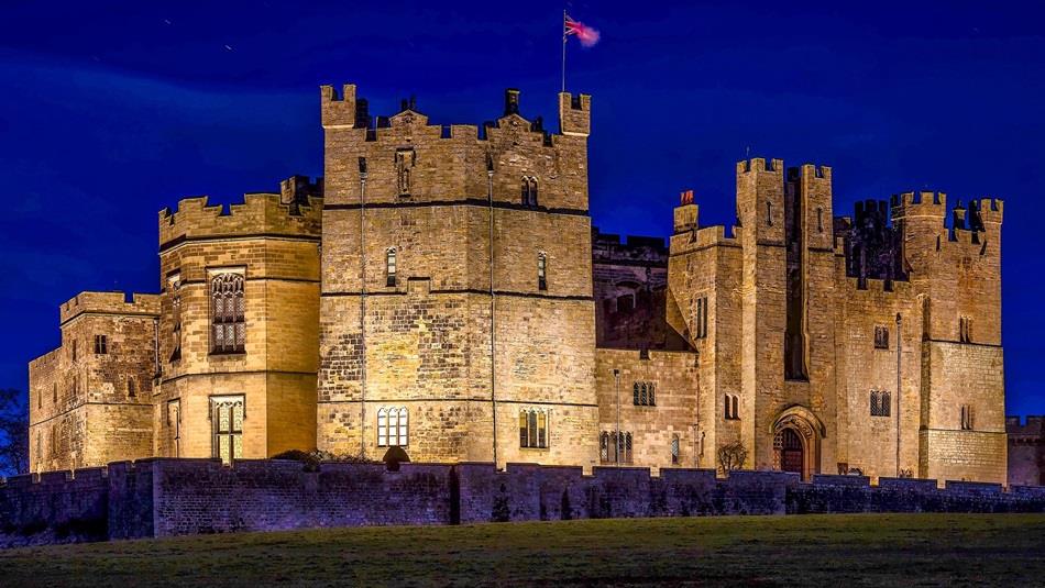 Raby Castle lit up at night time