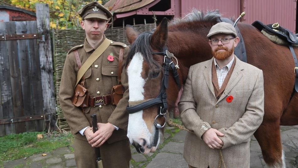Two people standing with a horse, one in military uniform.  Remembrance Sunday at Beamish