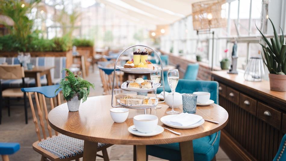 The Glass House restaurant with a table set for afternoon tea.