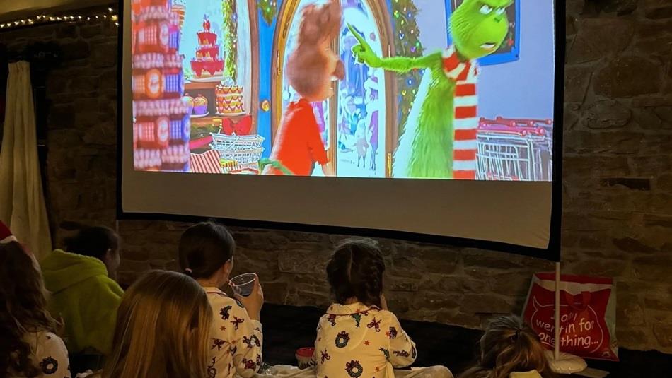 Children watching a Christmas film on the big screen