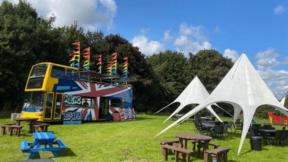 Grounds of Ushaw set up with picnic benches and tents in the sunshine