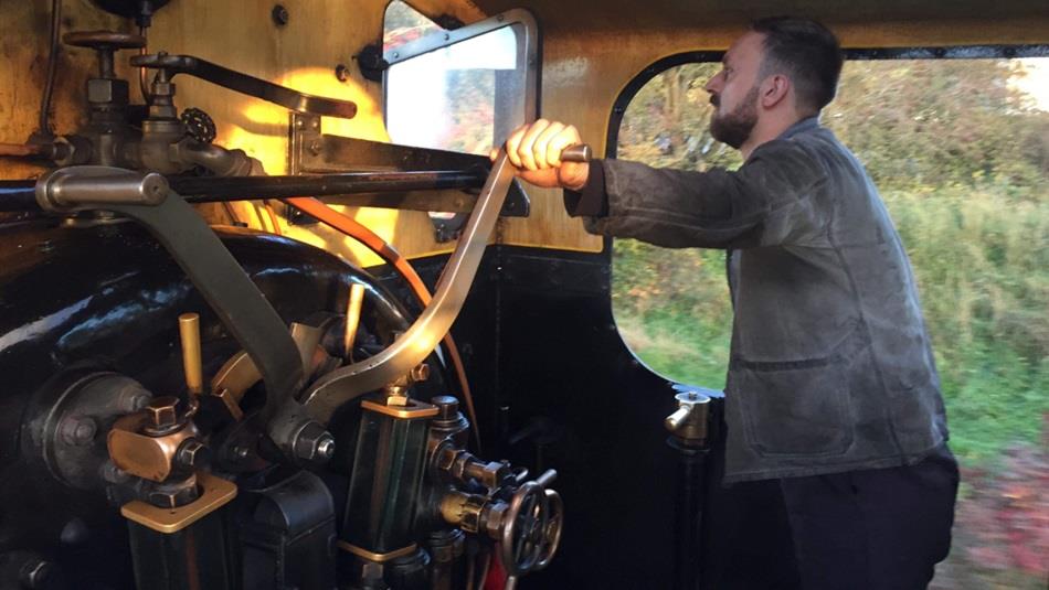 Someone taking control of a historic Steam locomotive.