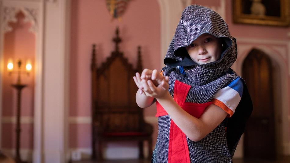 A child in Auckland Castle dressed as a knight