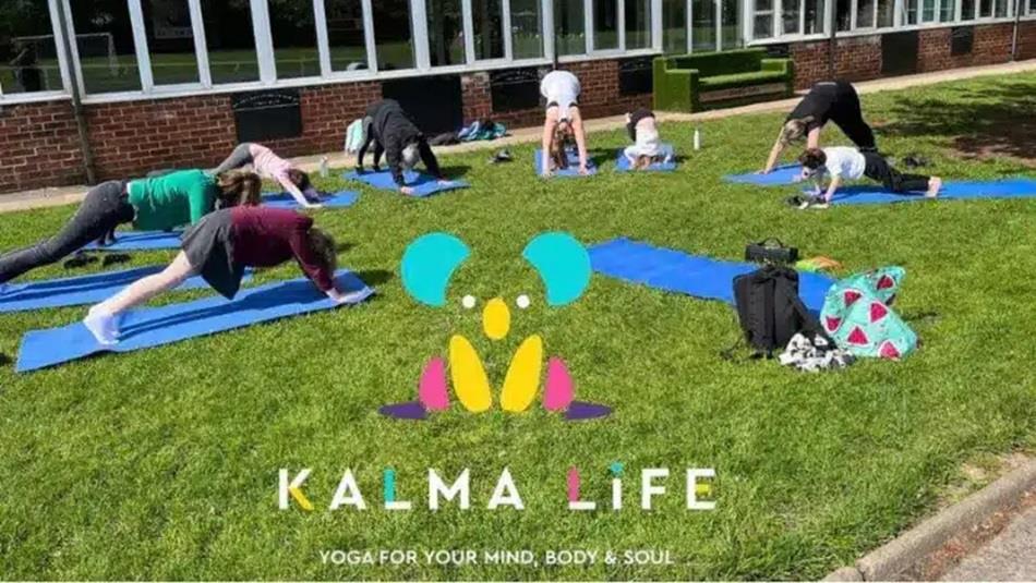 People doing Yoga outside in the sunshine