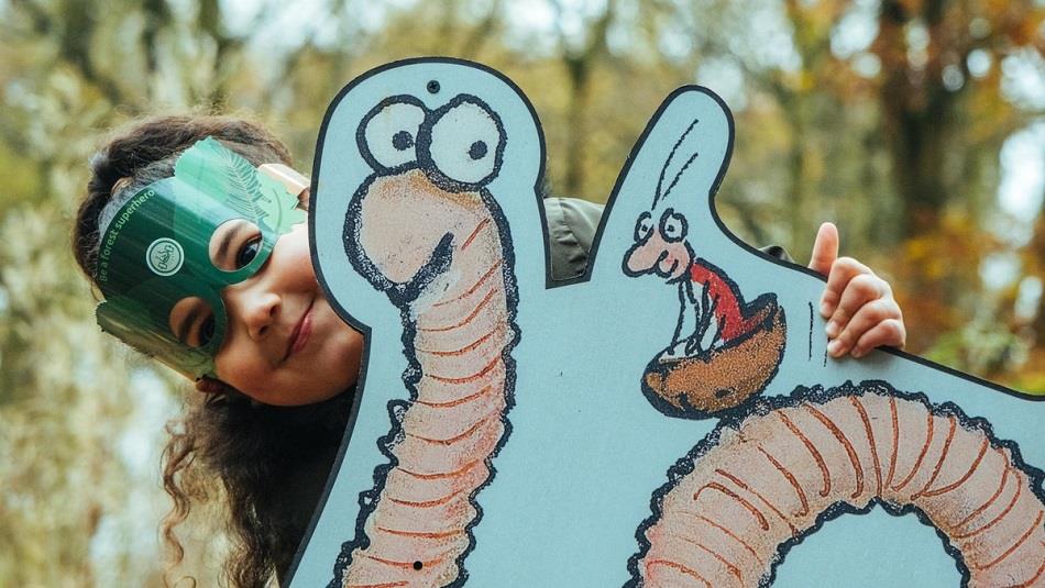 Image of child with a picture of Superworm