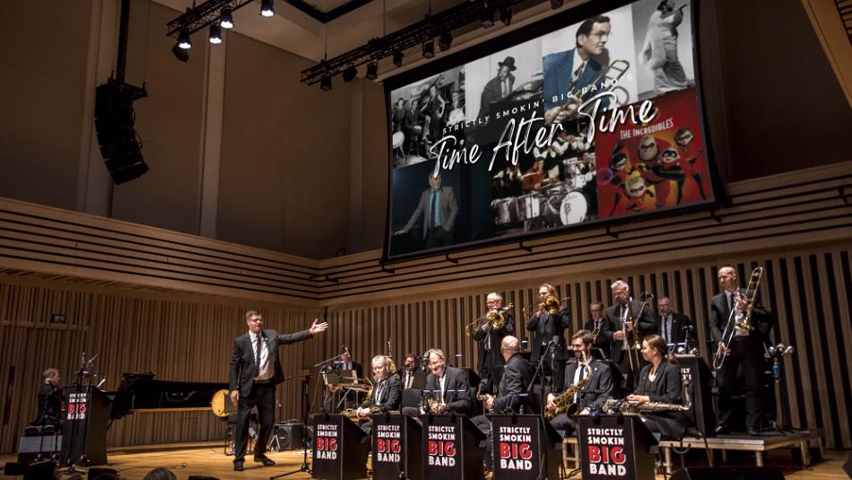 photo of Strictly Smokin' Big Band on stage with screen behind
