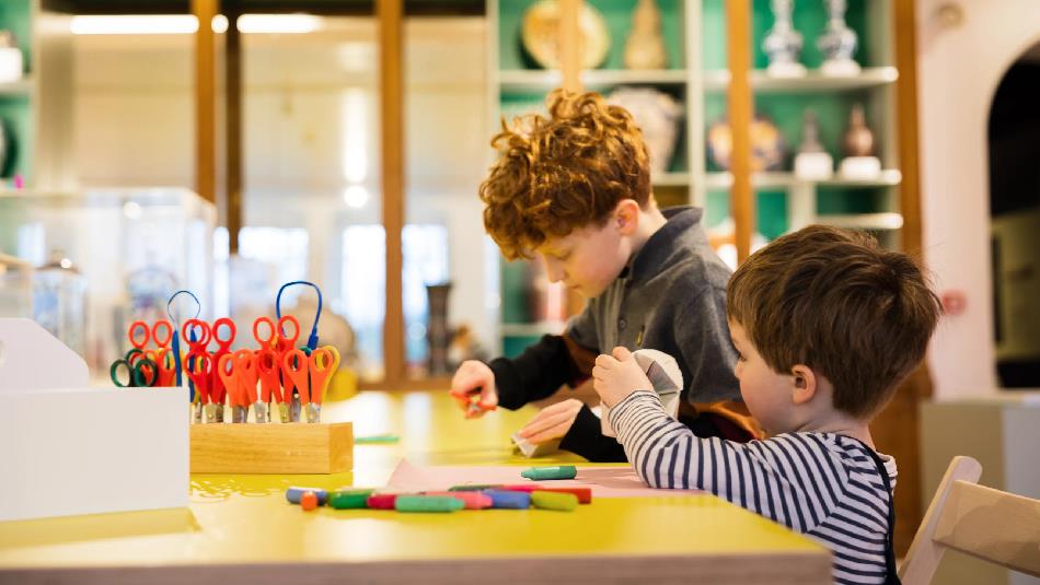 Two children participating in Arts and Crafts activities at The Bowes Museum