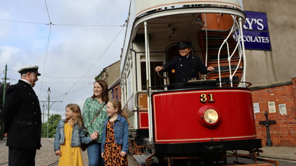 A family speaking to Beamish Museum staff before boarding the tram.