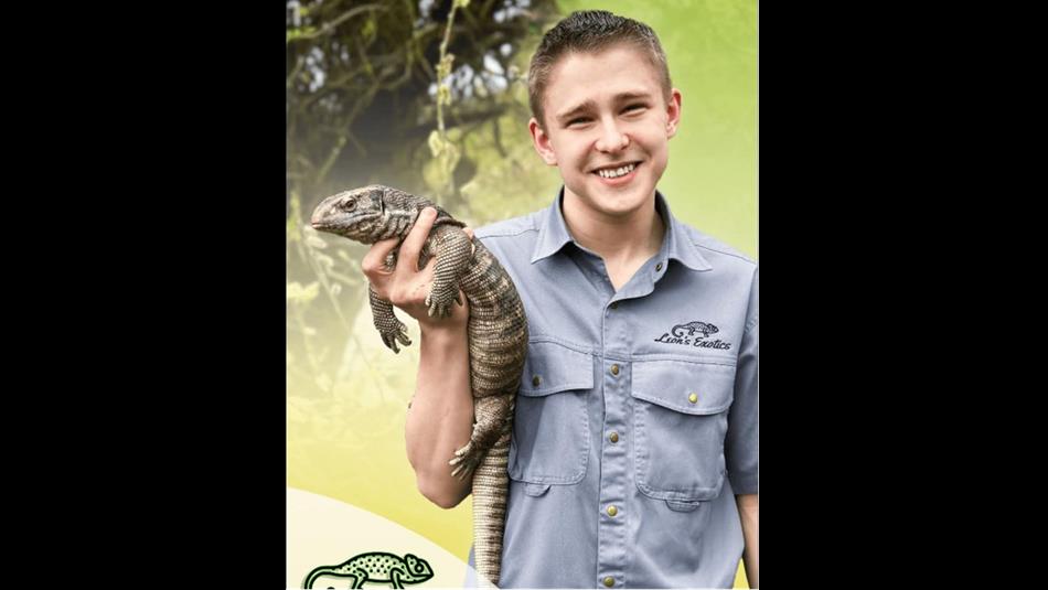 A child holding a reptile.